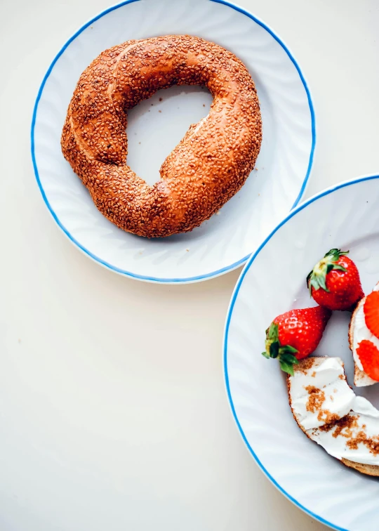 two white plates filled with fruit and a bundt cake