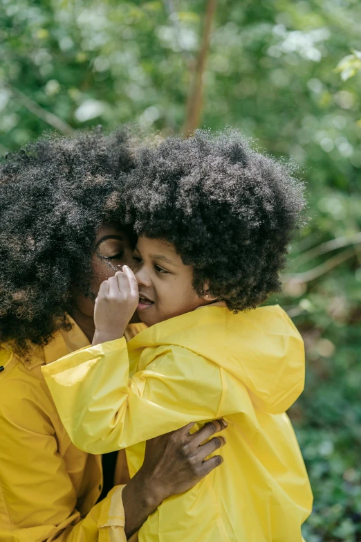 two woman hugging each other outside during the day