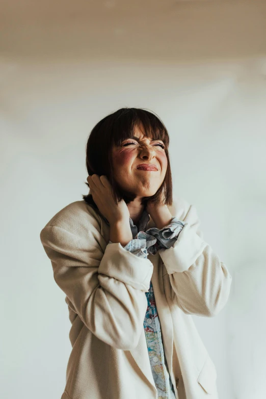 a young woman wearing a jacket, necktie and glasses