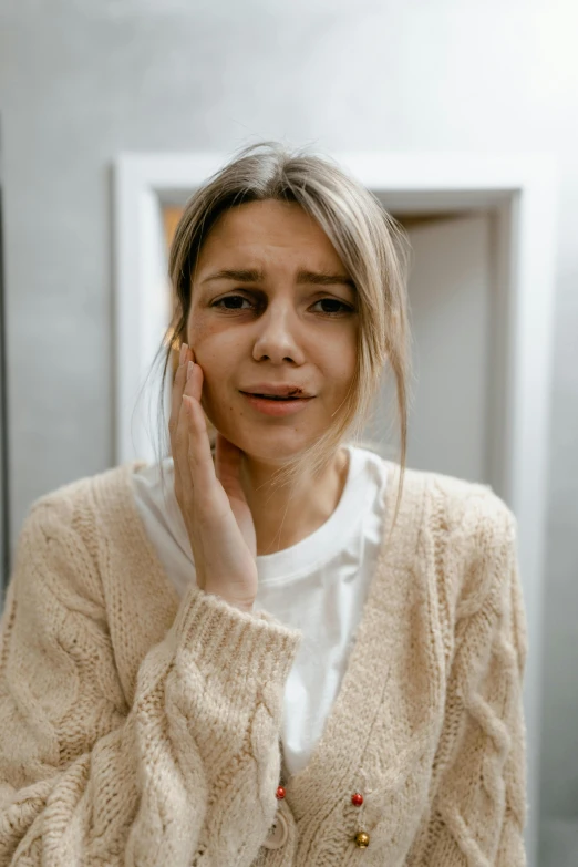 a woman posing for the camera in a sweater