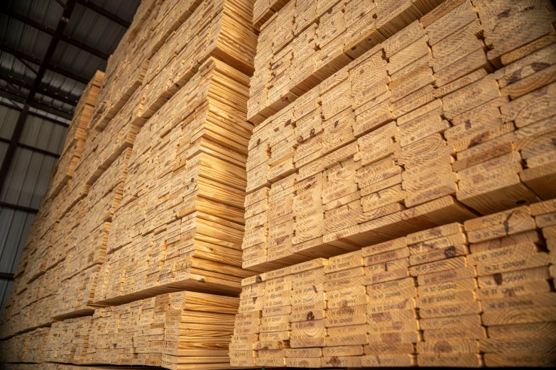 the stacks of unfinished wood are stacked together