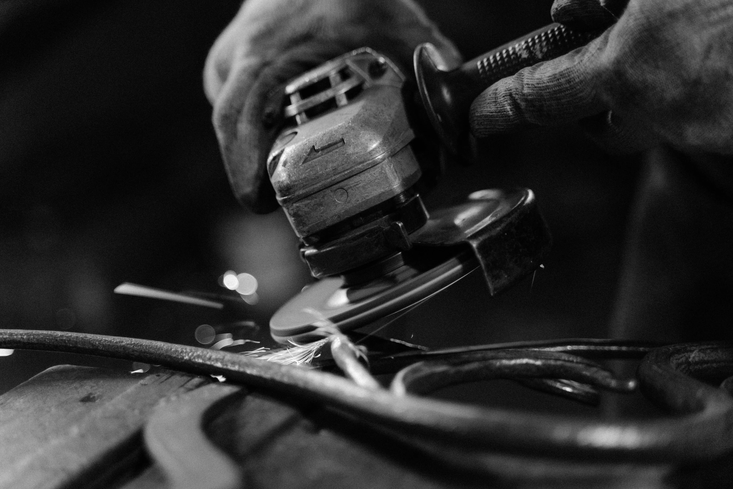 someone using a drill gun to repair an object