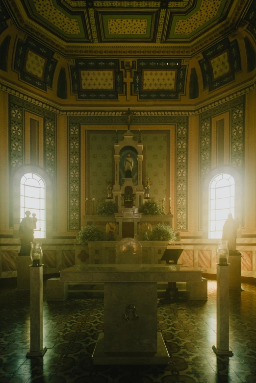 a large cathedral with candles in front of two windows