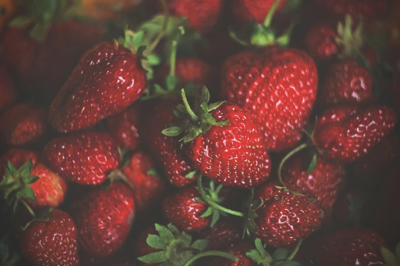 a closeup of fresh strawberries in a pile