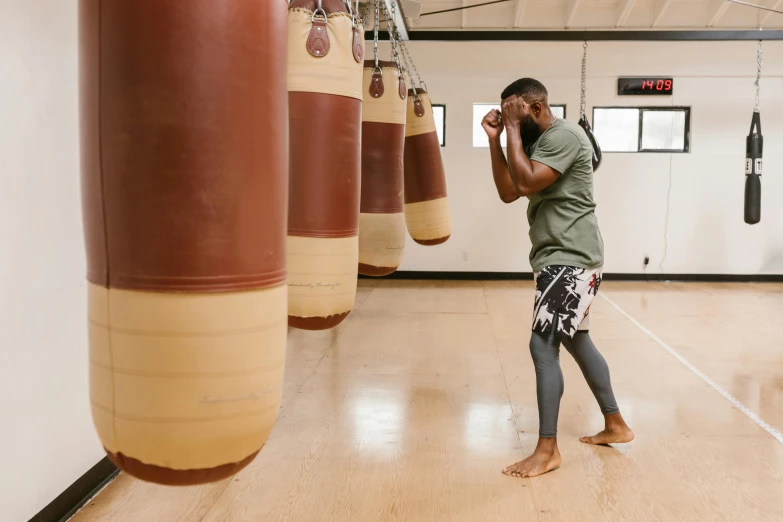 a man is standing in a gym talking on his phone