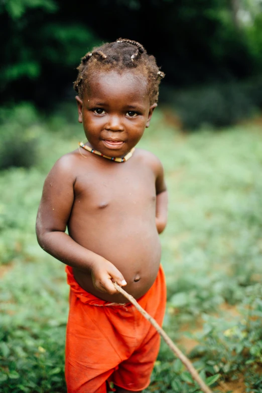 a child with very large  smiles for the camera