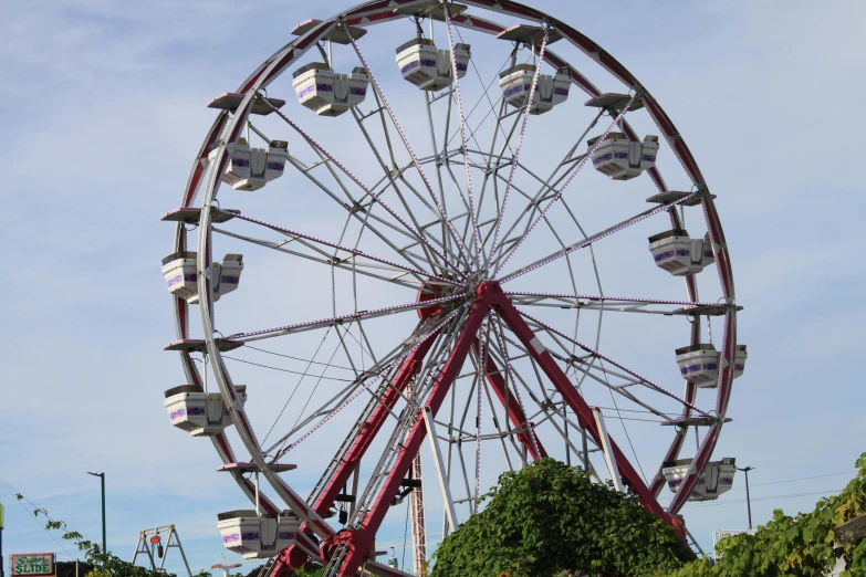 a red ferris wheel sitting on top of an amut park