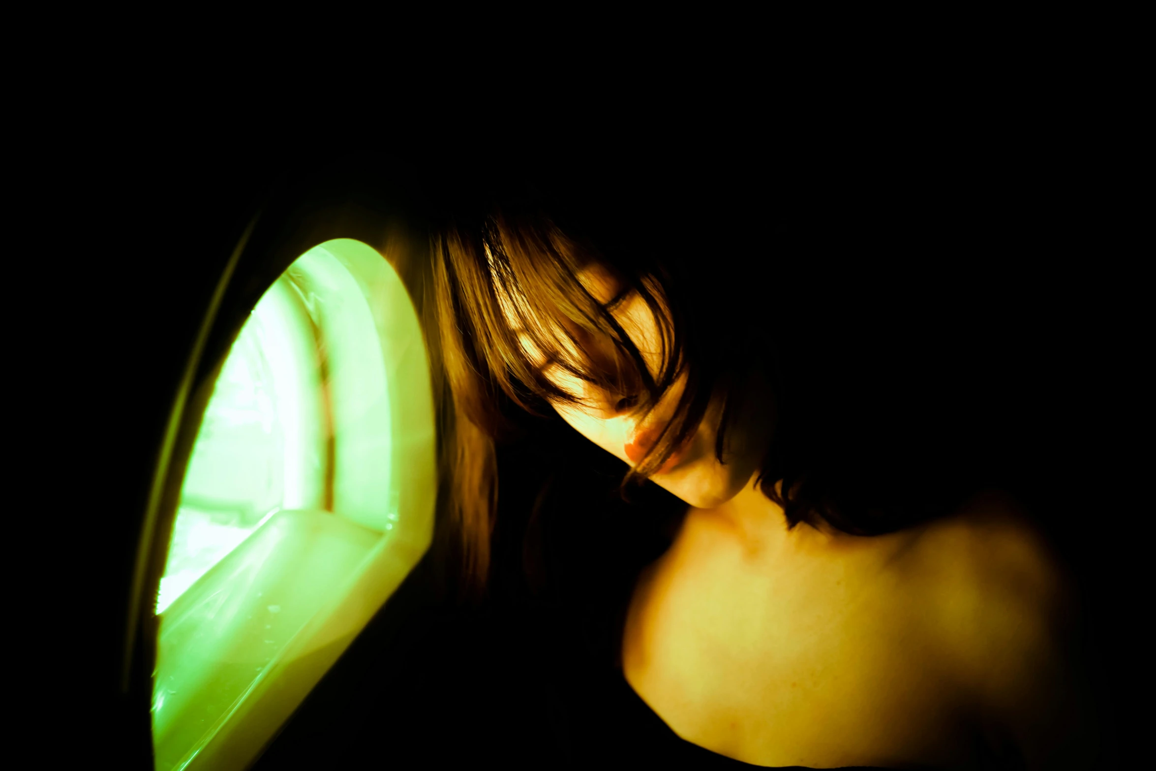 a woman holding onto an illuminated green object