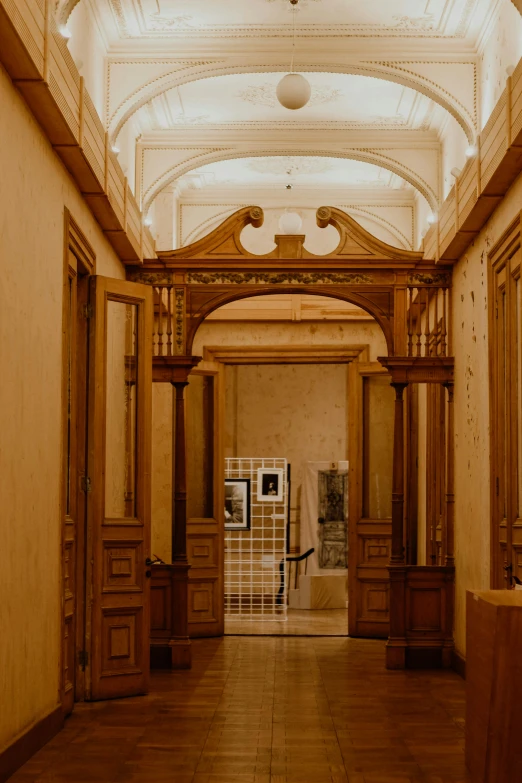 a large long hallway with wooden columns and ceiling