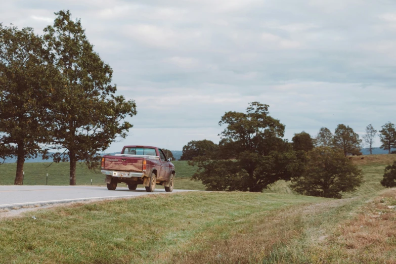 a large truck sitting on the side of a road near trees