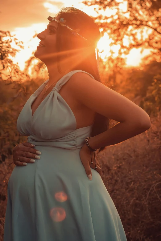 a woman in a dress standing in a field