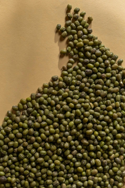 green peas spread in an upside down triangle on paper