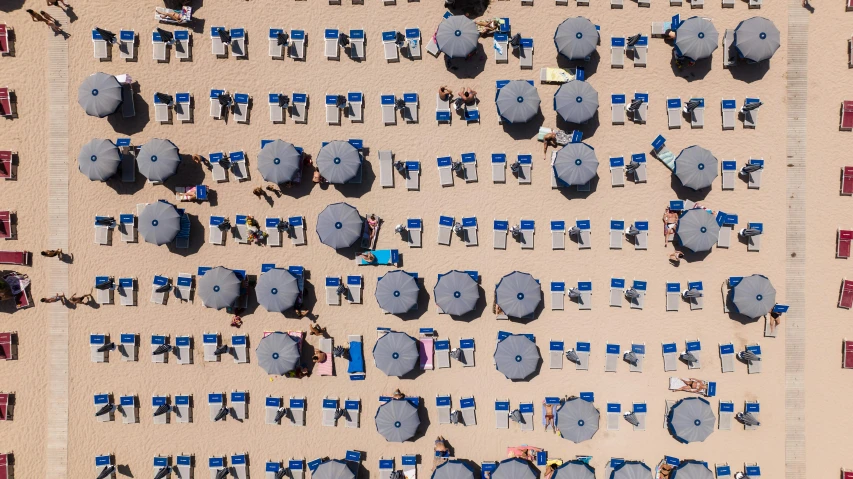 a group of beach chairs and umbrellas on the sand