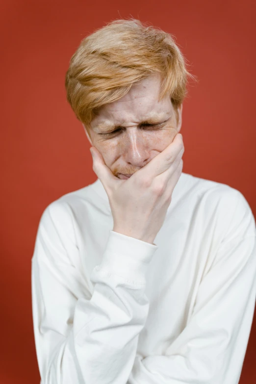 a girl with blonde hair wearing a white shirt