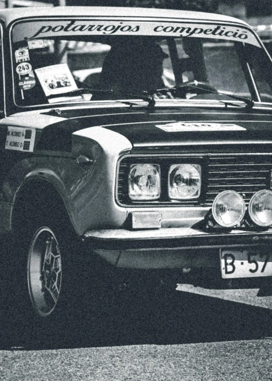 a black and white po of a car with a rally sign on it's windshield