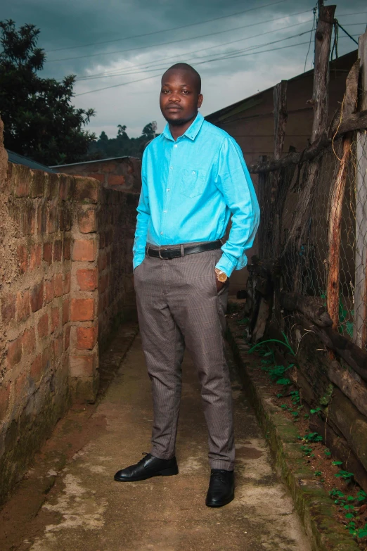 a man stands in an alley way between some brick walls