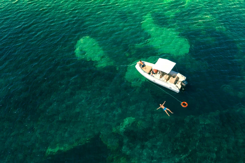 a couple is rowing their boat in the crystal green ocean