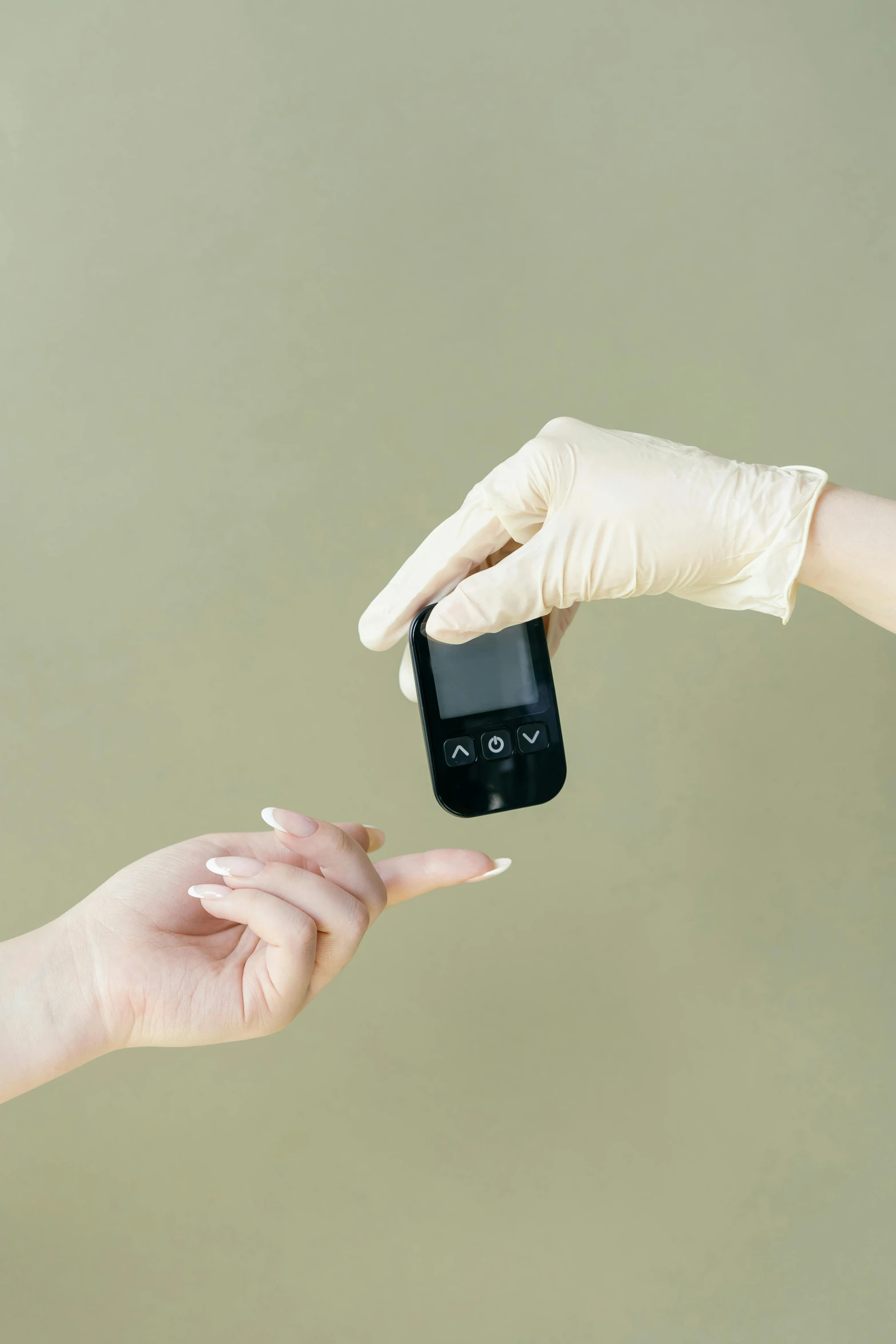 hands wearing gloves holding an object in the palm