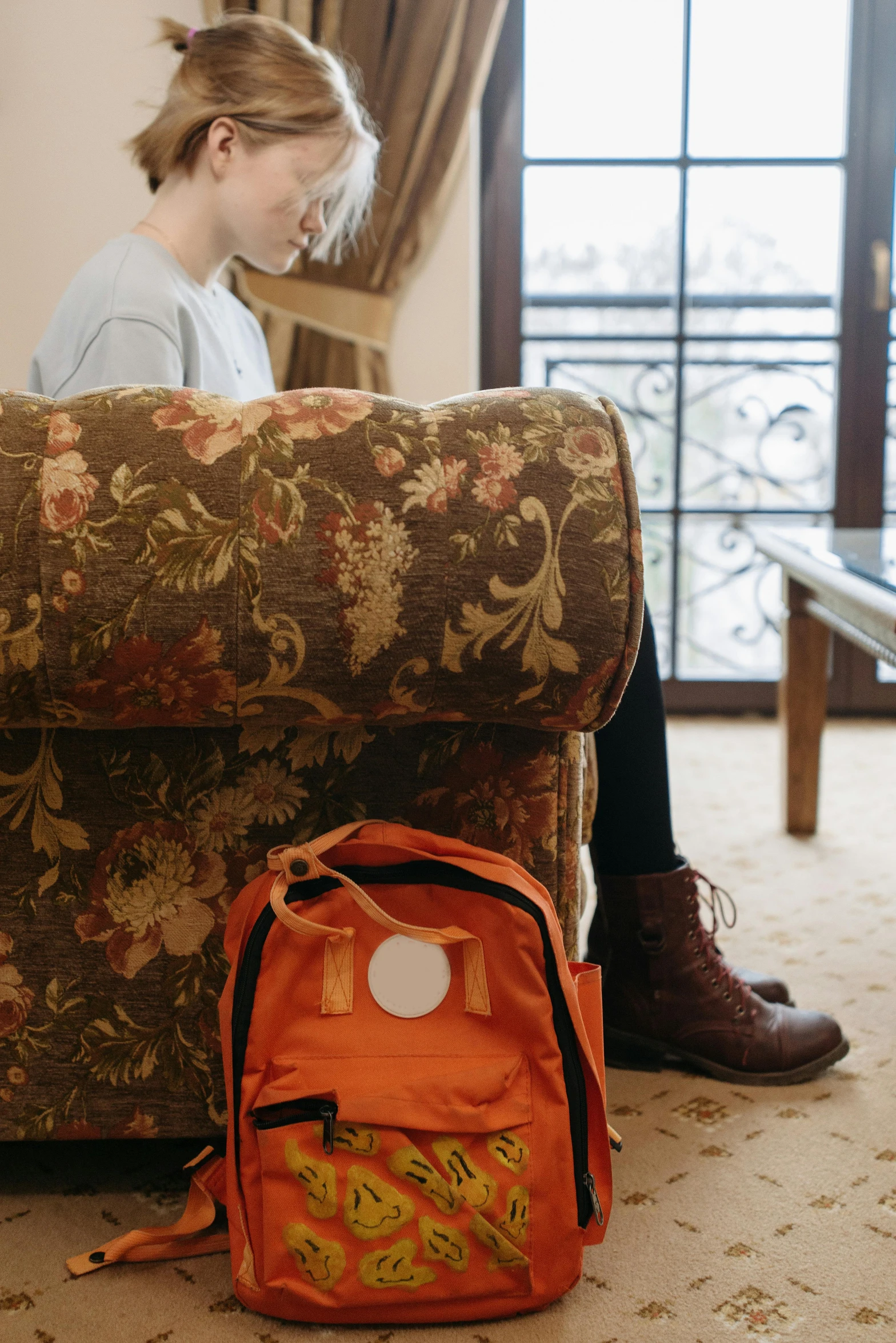 a person sitting on the floor near a chair