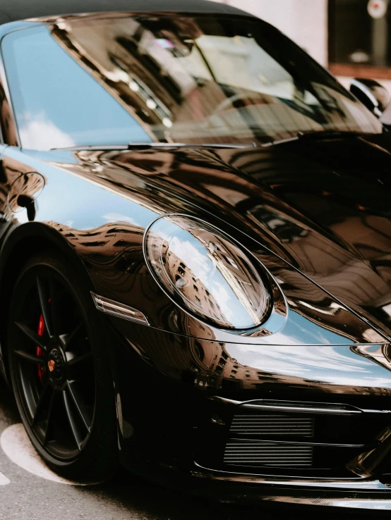 a black sports car sits parked on the street