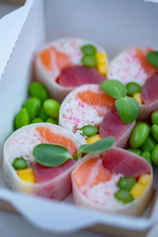 food in a white paper container with green peas