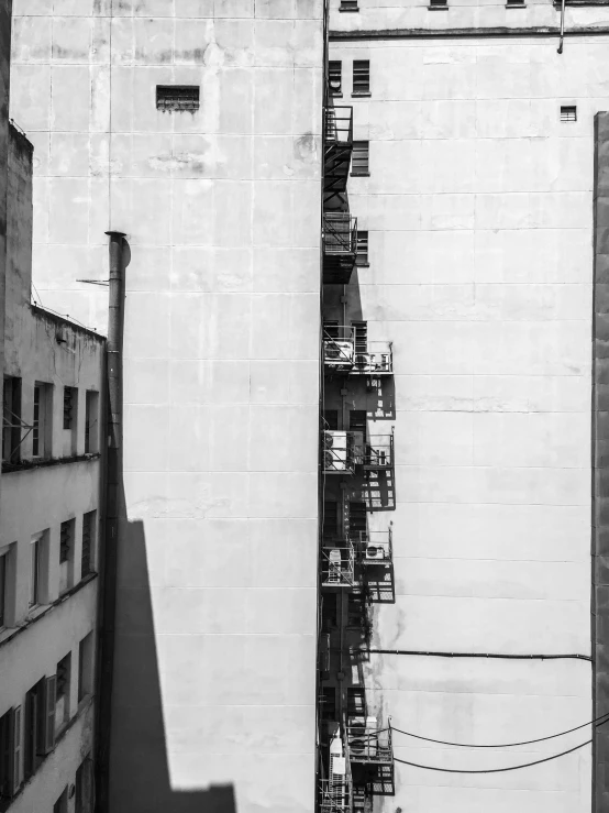 two tall buildings side by side with one building on one side