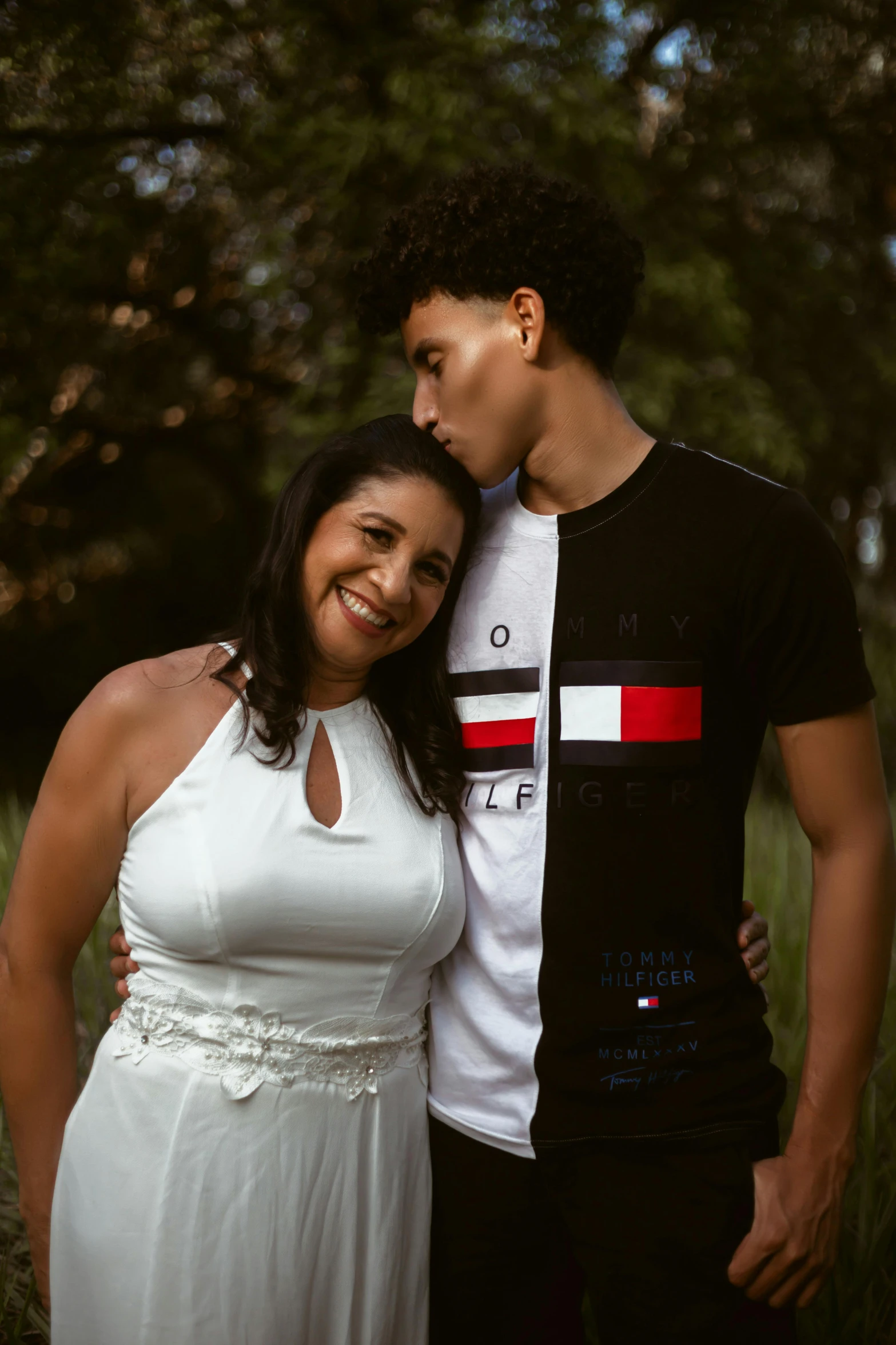 a woman in a white dress standing next to a man