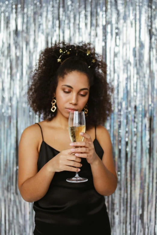 a woman in black holding a wine glass