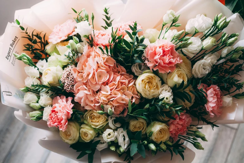 a bouquet of multi colored flowers sitting on top of a white tablecloth