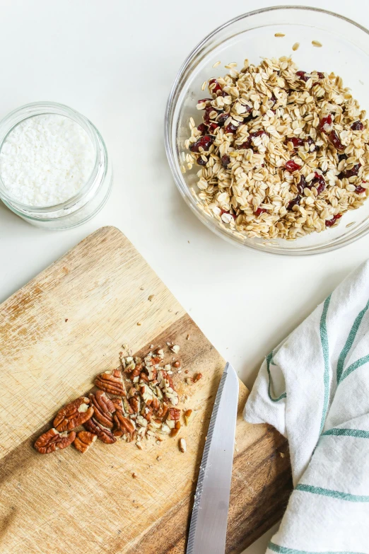 a wooden  board topped with granola and a bowl