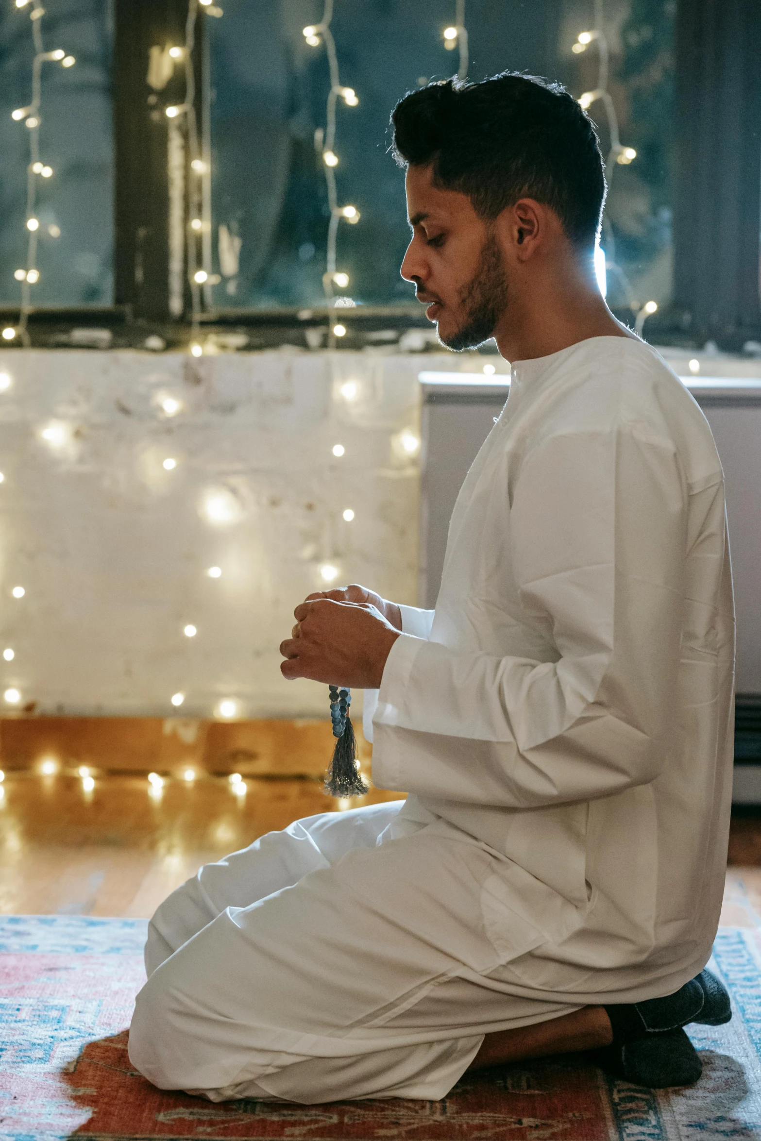 a man is sitting on the floor playing a game