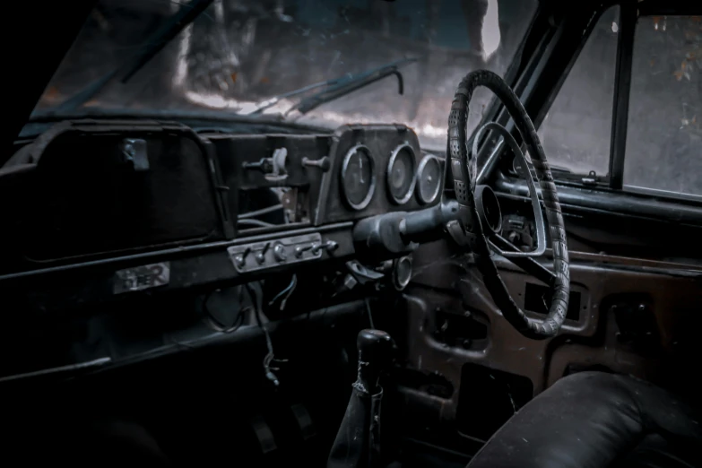 an old truck with steering wheel and other parts hanging from the ceiling