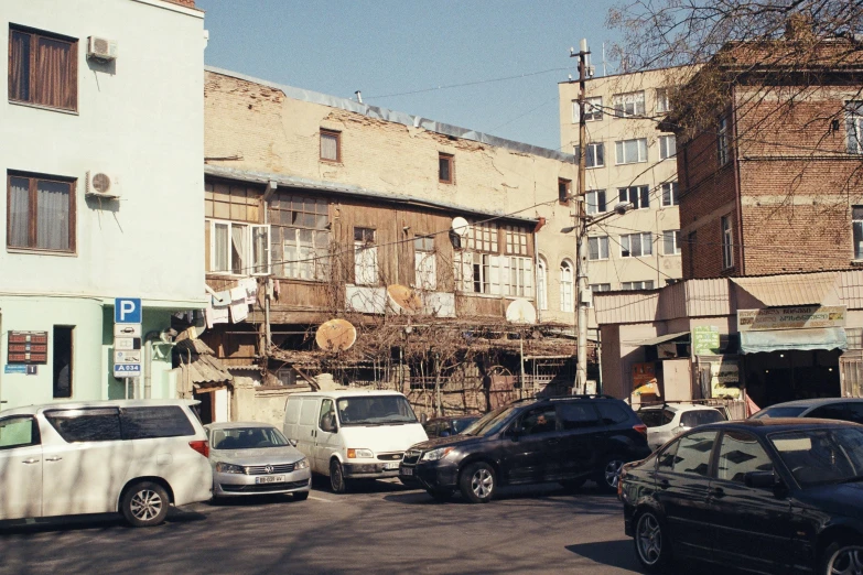 a city street filled with parked cars and traffic