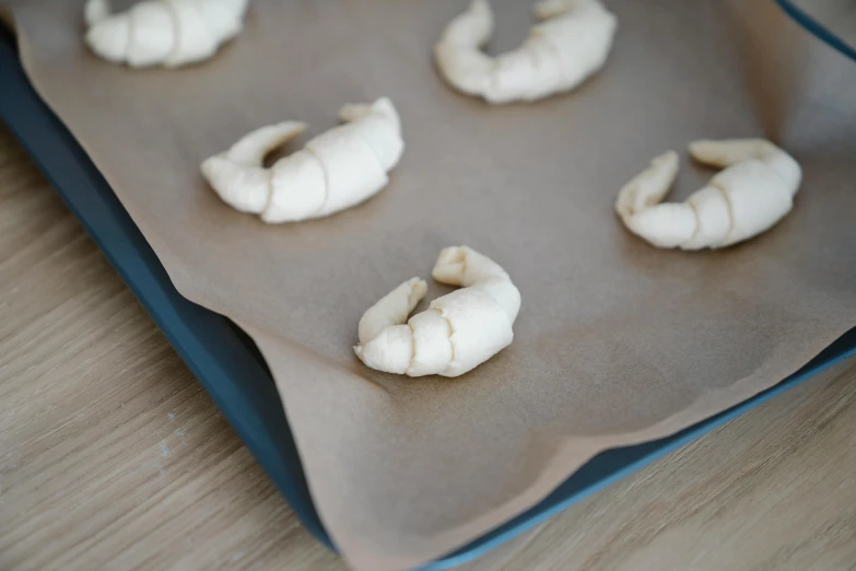 some bread pieces are being prepared and put in some tray