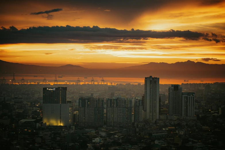 a sunset over the city skyline is seen