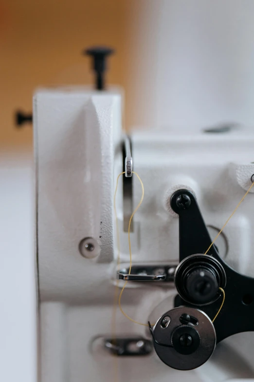 there are two pairs of sewing needles attached to a sewing machine