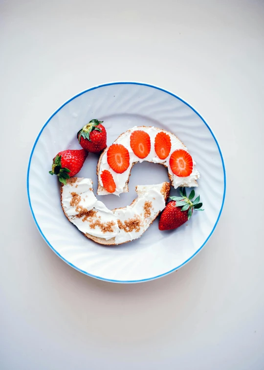 an orange and white plate with some fruit on top