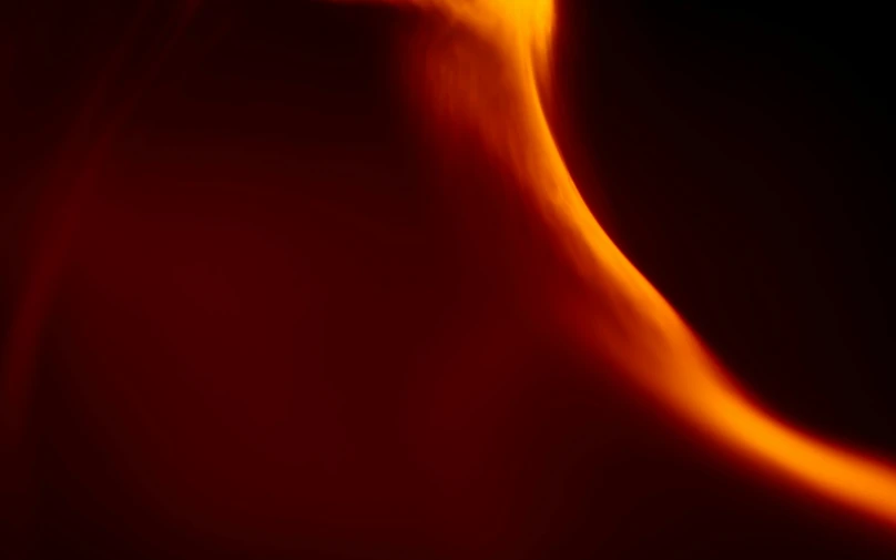a close up of a red fire flame with many swirls