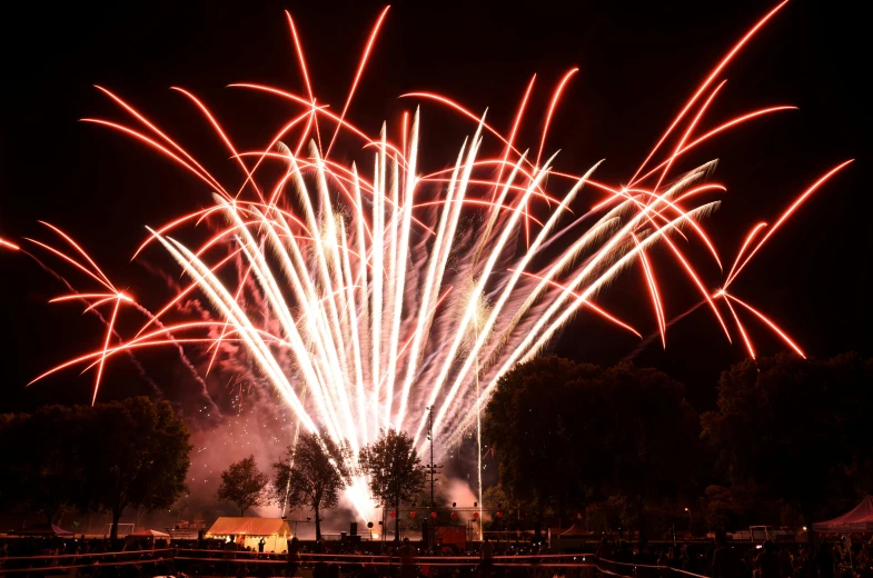 a large fireworks is lit up in the night sky