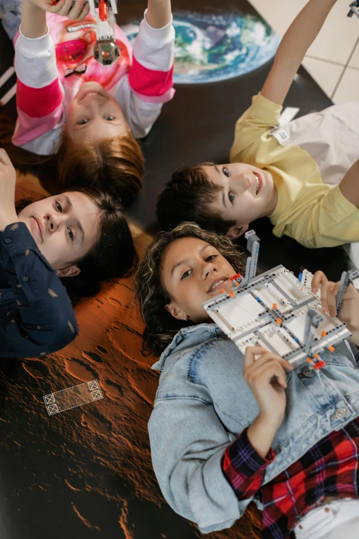 some girls playing and laughing together on the floor