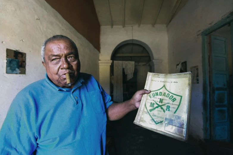 an elderly man smoking on his cigar and holding a bag