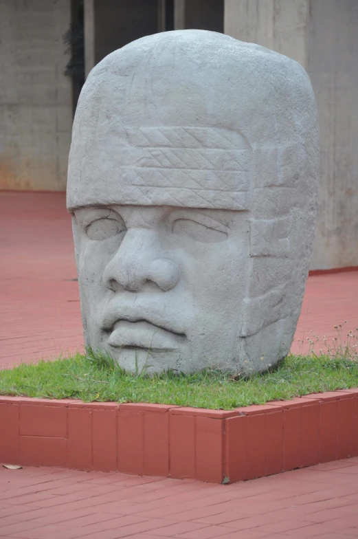 a fake face on display on the sidewalk