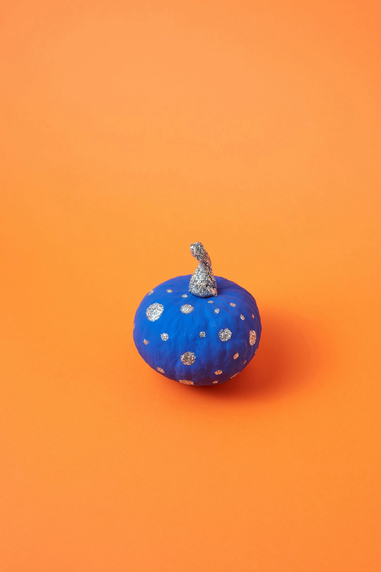 an image of a blue pumpkin on orange background