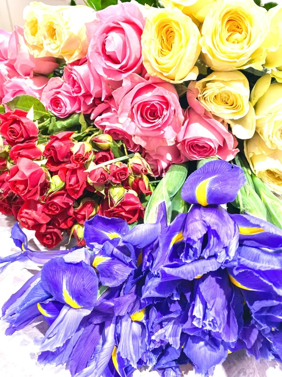 bunches of roses and other flowers placed on a table