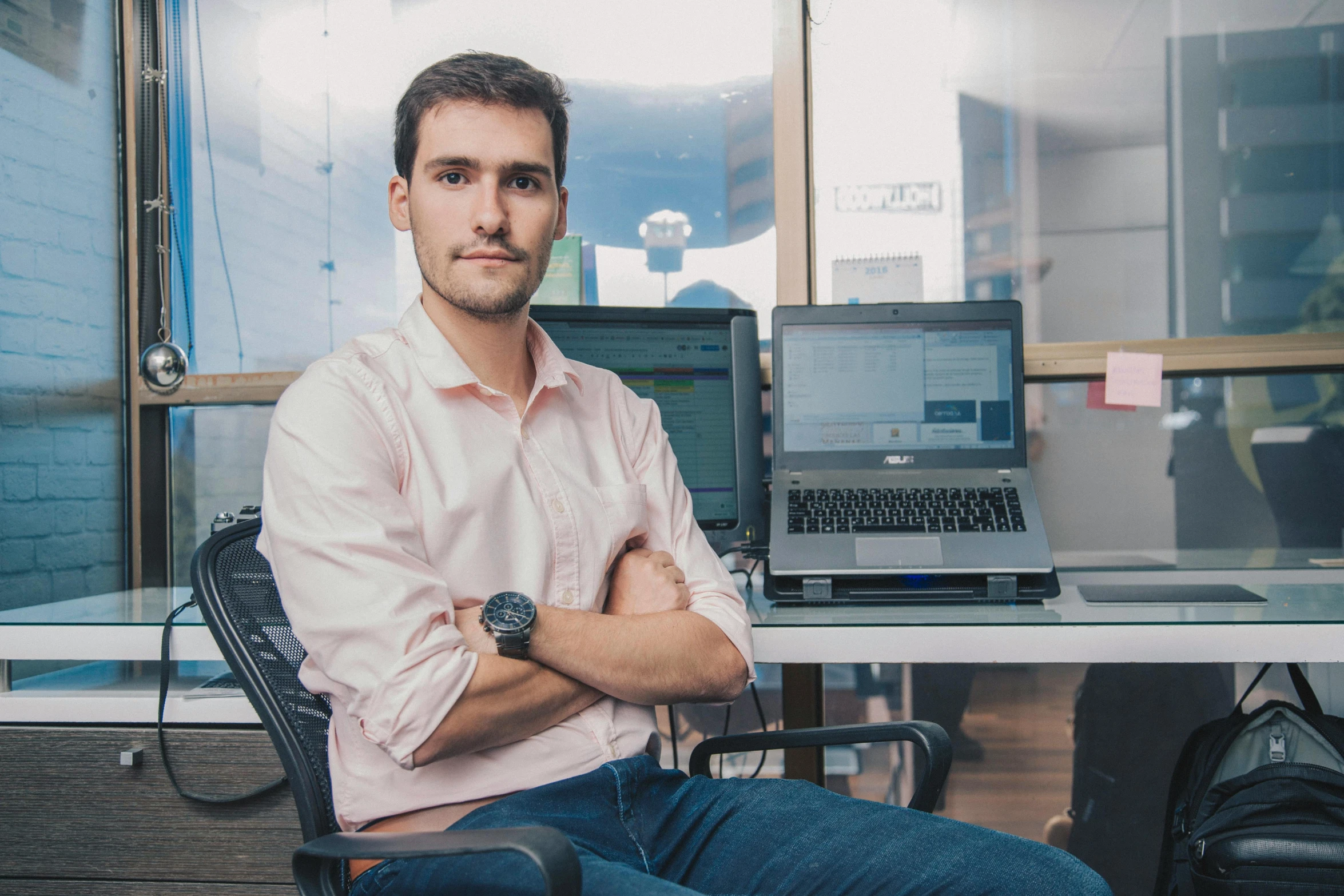 a man sitting at his desk in front of his laptop computer