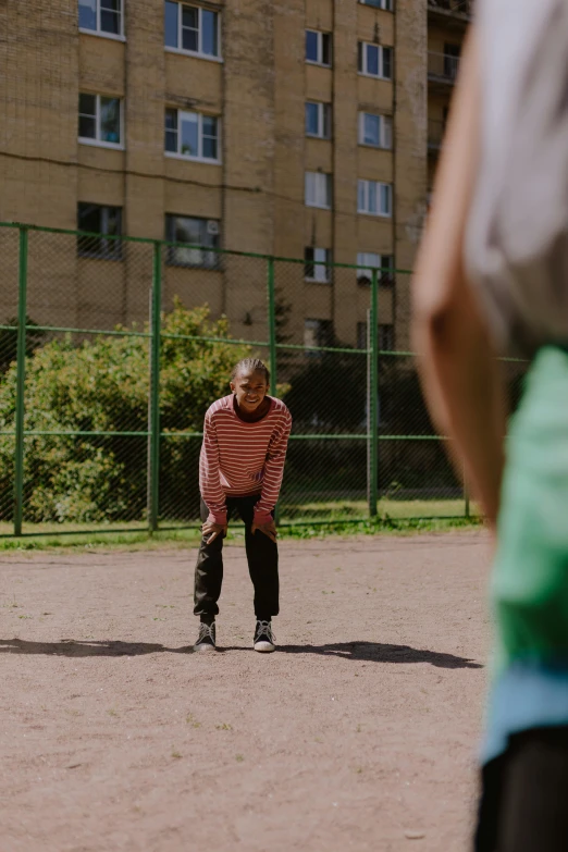 a man with glasses playing baseball with others in the field