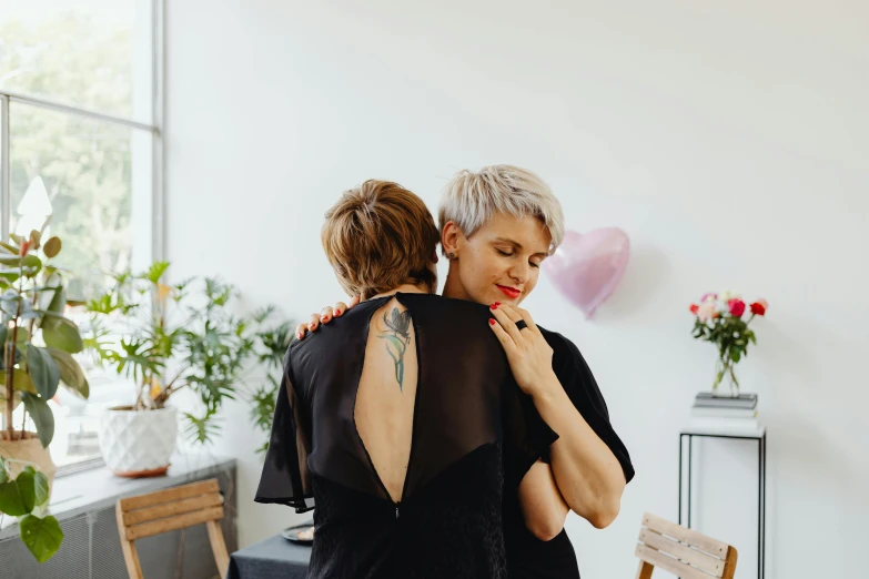 a couple hug each other while standing in front of a table