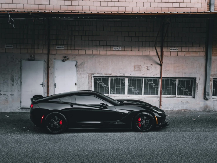 a black sports car parked in front of a building