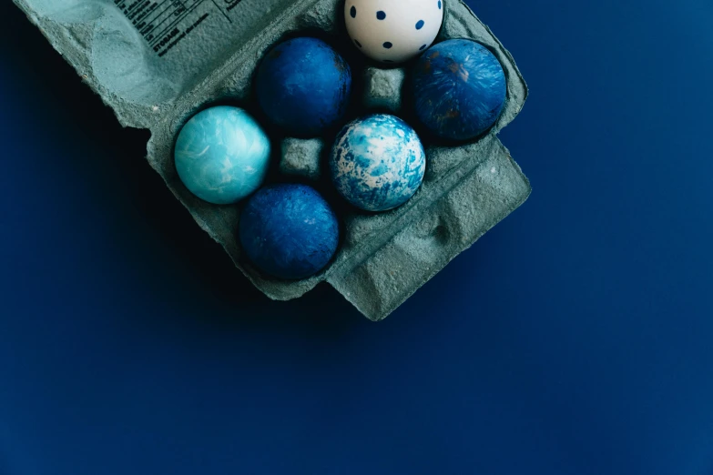 there is an old newspaper and some decorated easter eggs