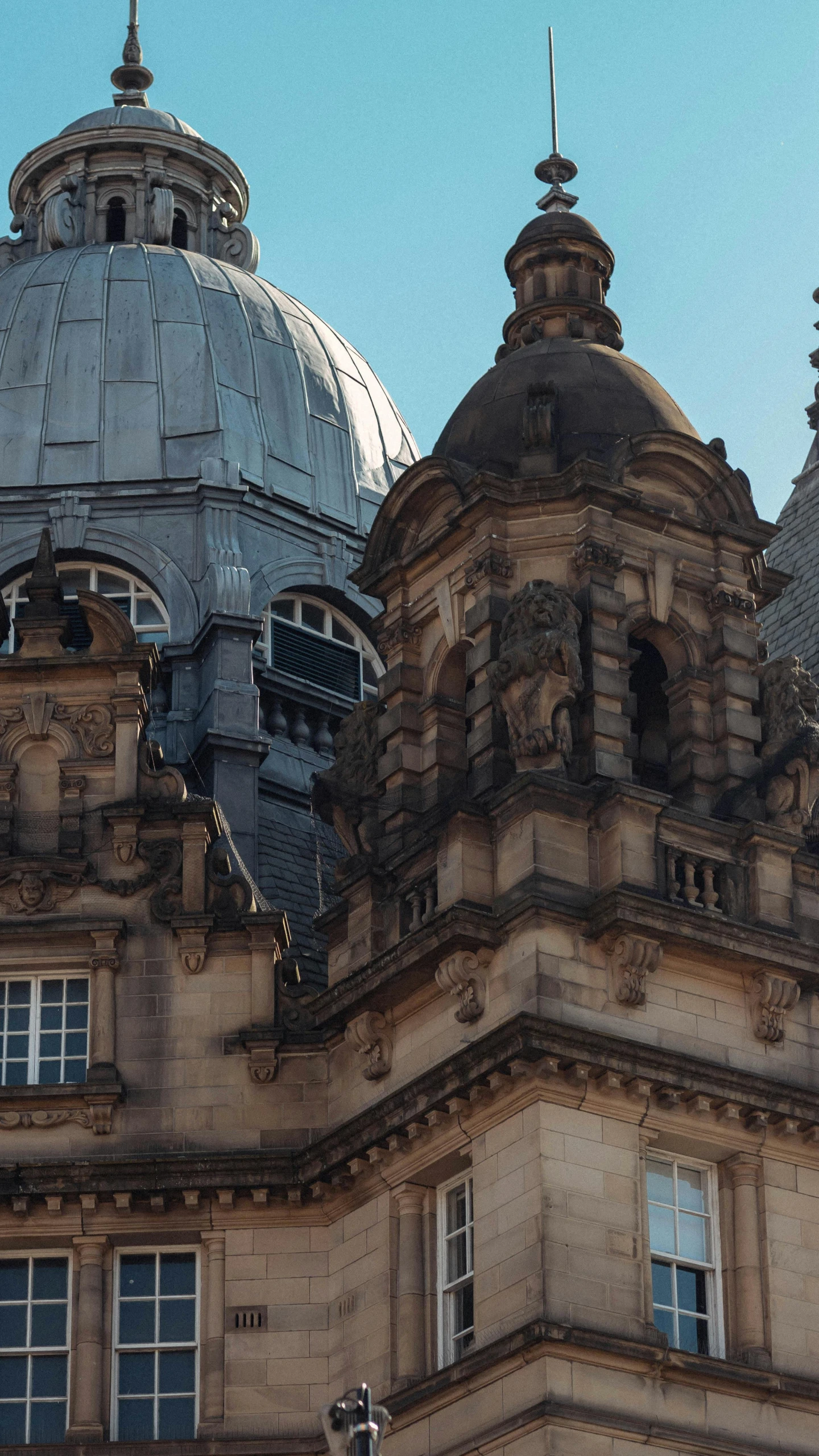 the roof of a large building with windows and a clock tower